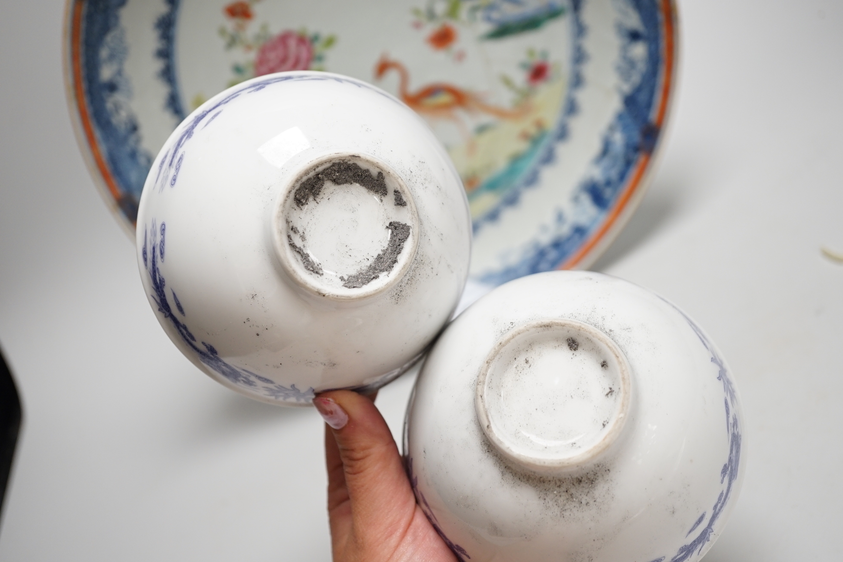 An 18th-century Chinese export famille rose twin pheasant dish and a pair of blue and white bowls, the largest 30cm in diameter